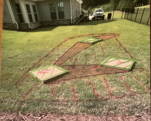 Cardboard boxes and turf marking paint help visualize the future location of the crevice garden.