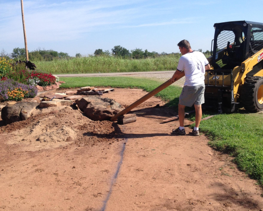 Using a wooden lever to shift rocks into place.