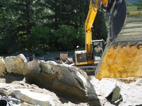 Rodney Smith deftly places one of the larger pieces of  Mariposa slate at the apex of the crevice garden.