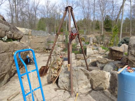 Lifting a tufa slab into place with a tripod and electric winch.